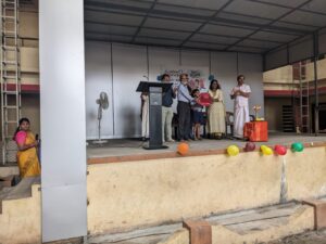 Muncipal chairperson Seema Kannan and Jose Parappilly jointly prsenting school kit to the student